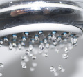 image of a silver shower head dripping water
