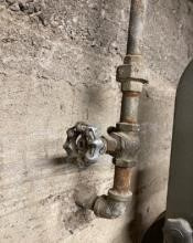 An image of a pipe entering a wall