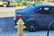 Car parked in front of a fire hydrant 