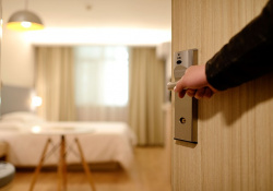 hand opening door to a hotel room