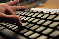 A hand typing on a keyboard