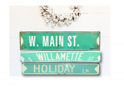 A nicely designed white wall with three retired street signs used for decor