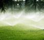 image of water sprinklers and lawn